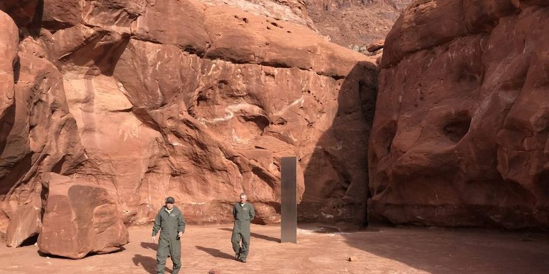 Workers examine the mysterious monolith